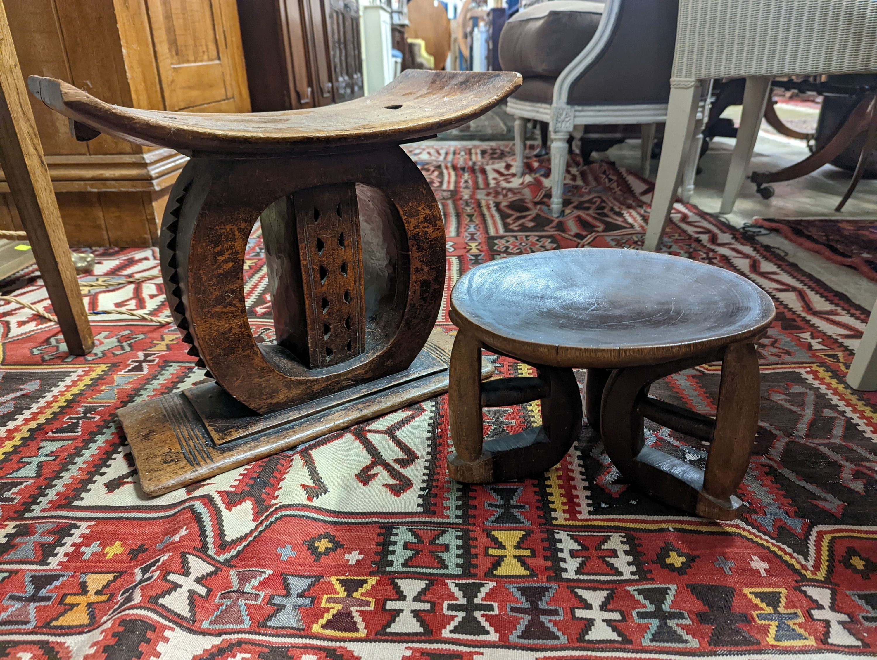 Two African carved hardwood stools, larger length 43cm, depth 19cm, height 37cm